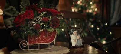 a picture of a couple on a table with a christmas tree in the background