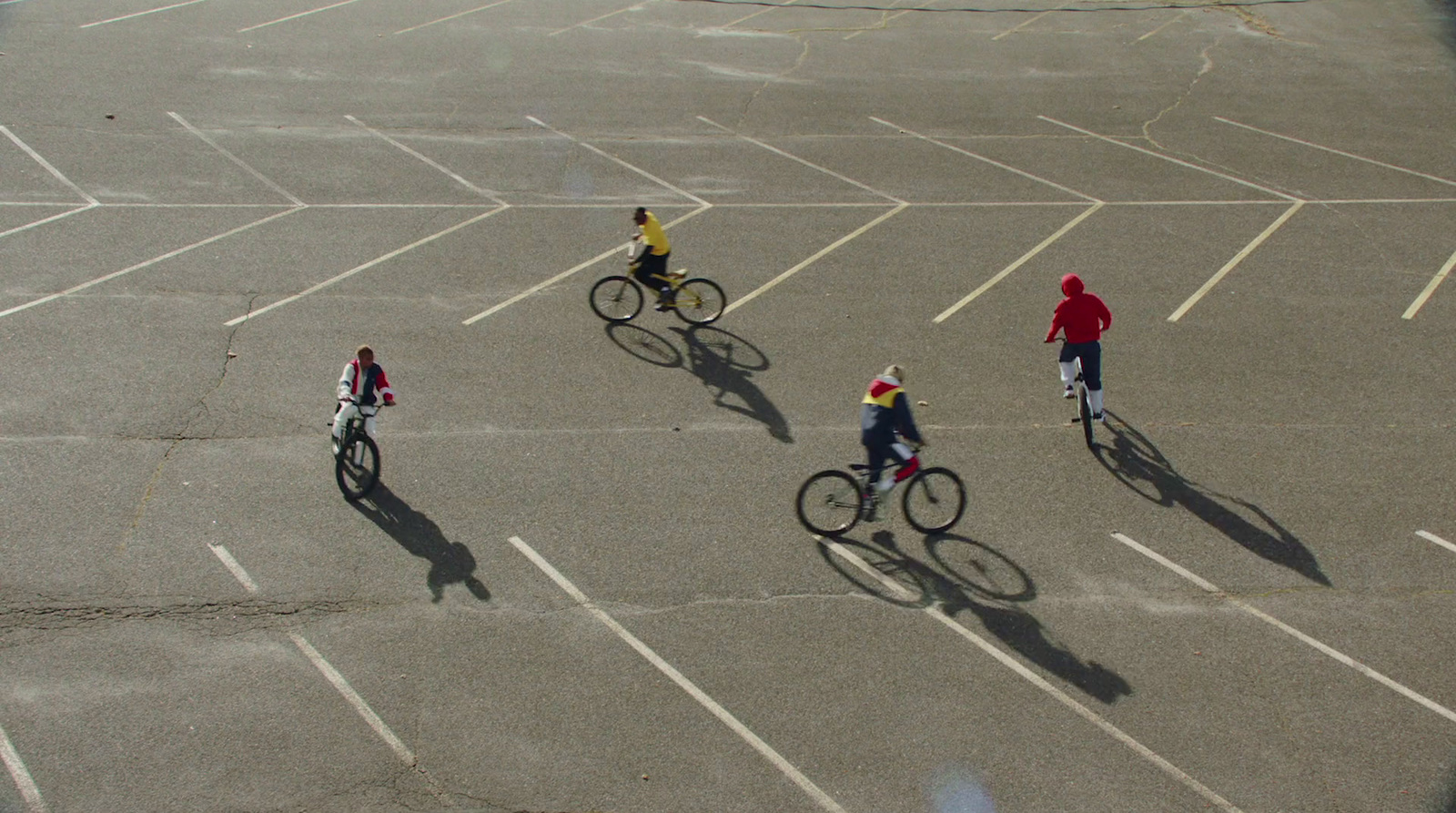 a group of people riding bikes in a parking lot