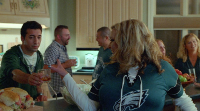 a group of people standing around a kitchen counter