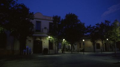 a dark street at night with street lights on