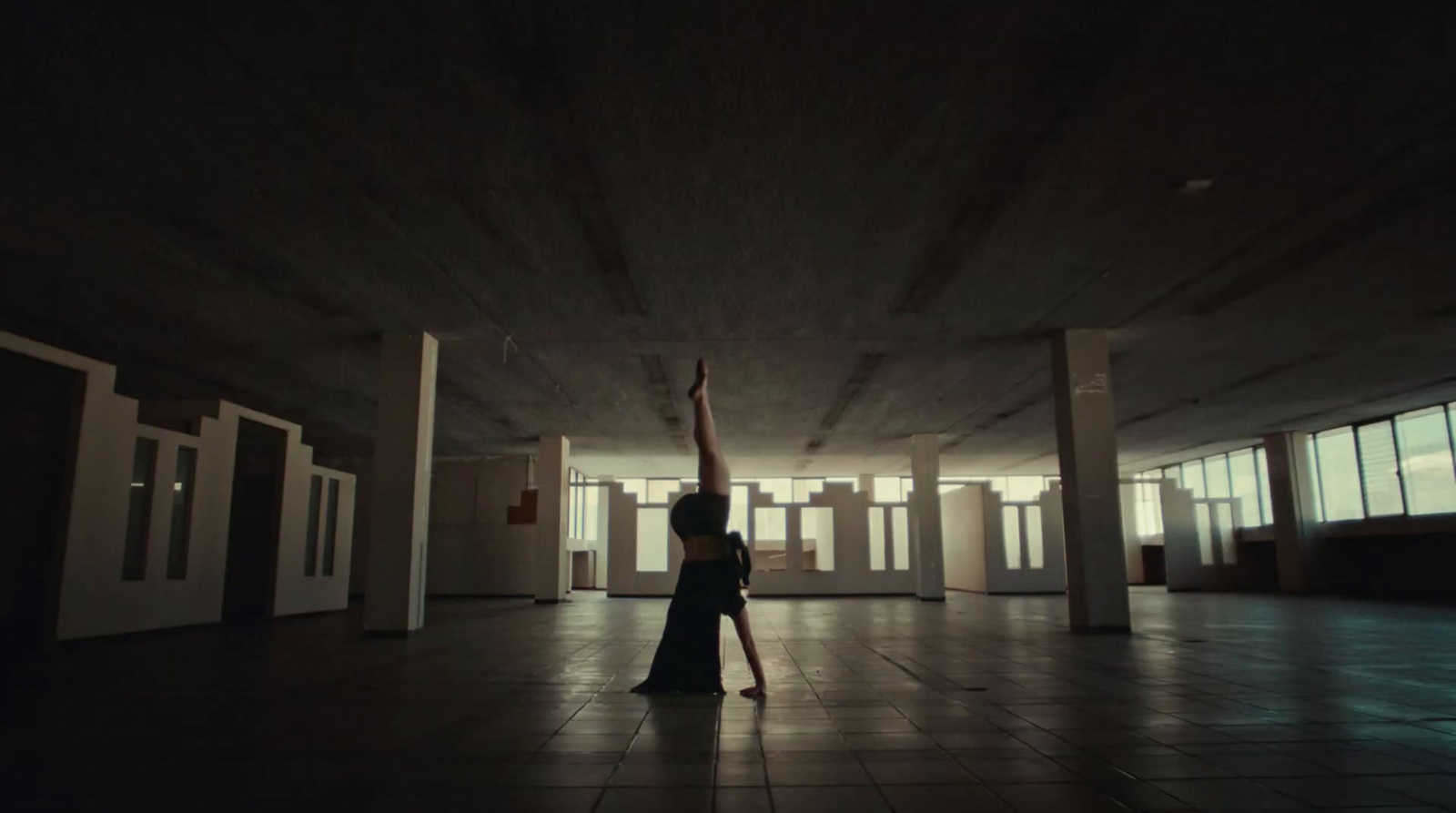 a woman standing in a room with a pole in her hand