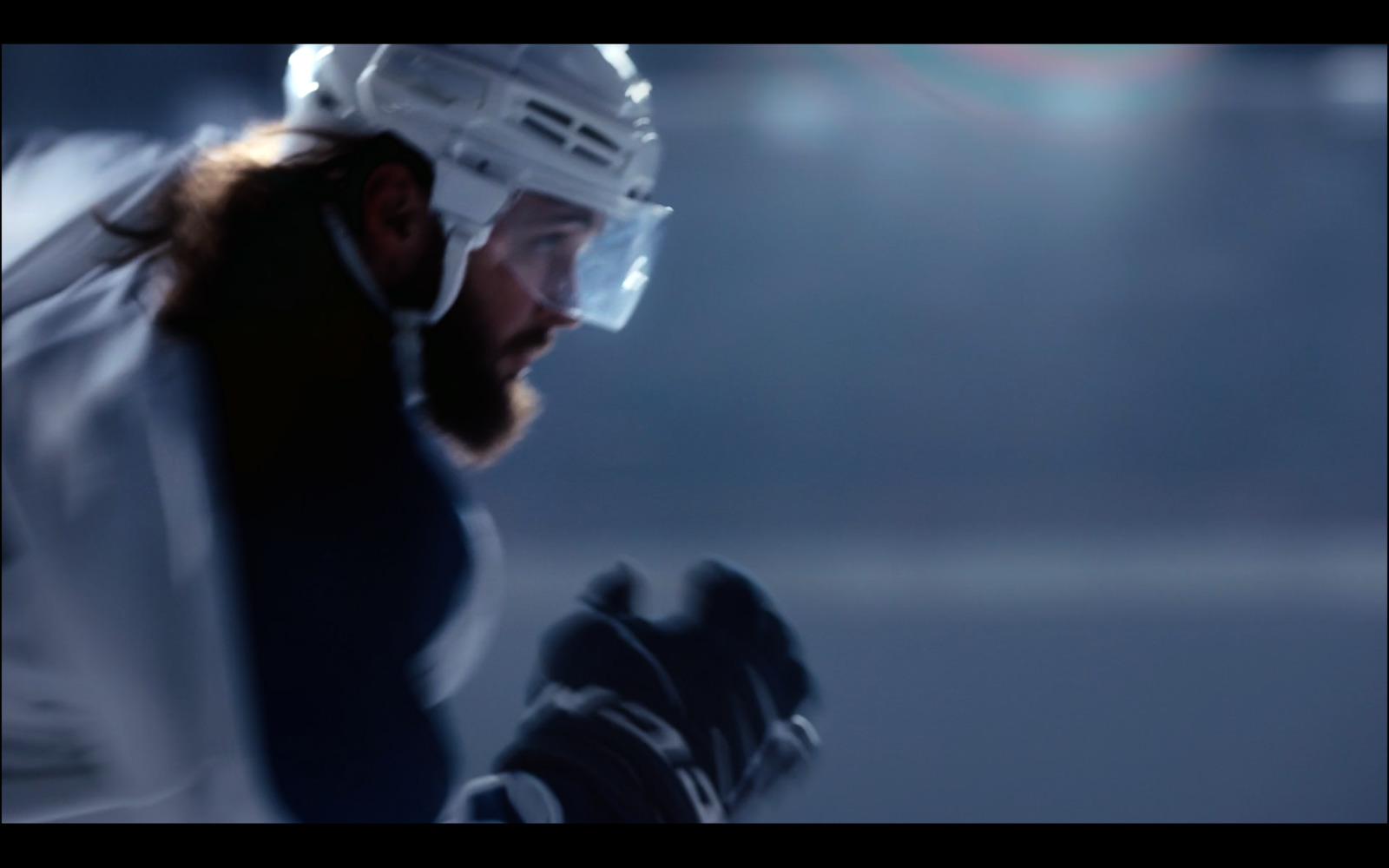 a man with a hockey helmet and gloves on