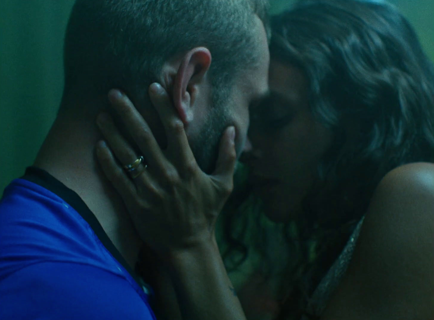 a man and a woman kissing in front of a mirror