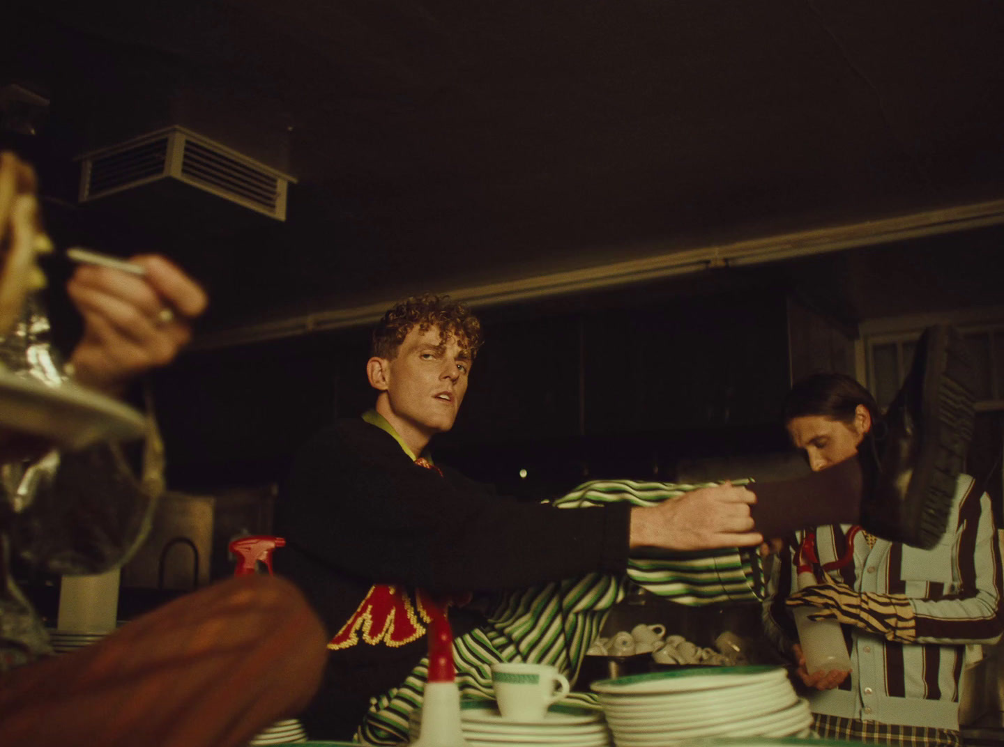 a man sitting at a table with a plate of food