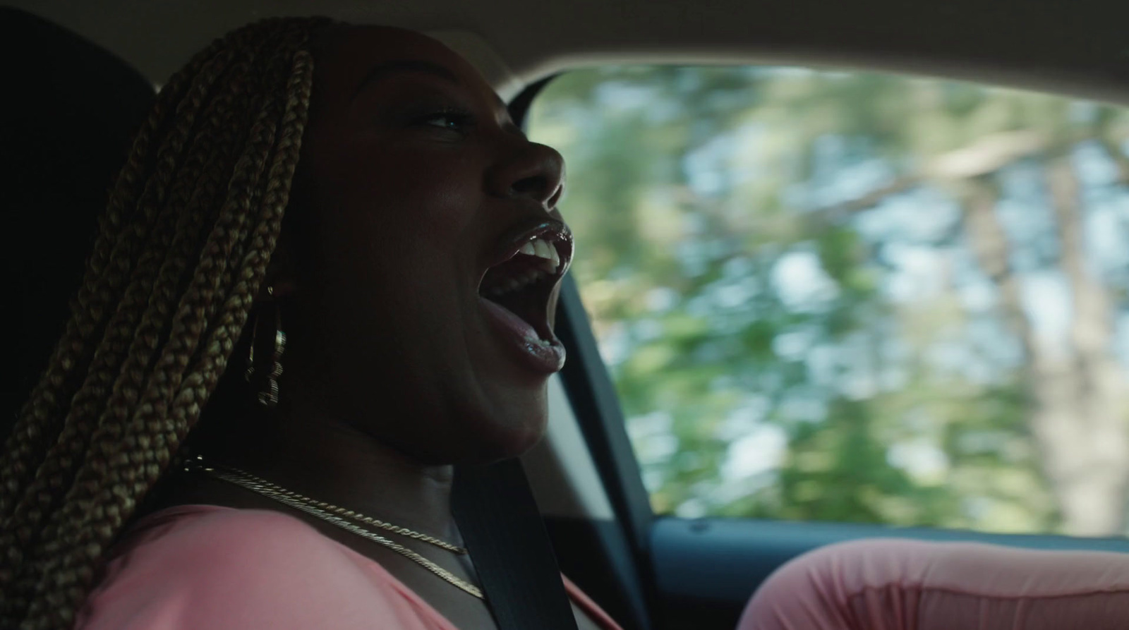 a woman in a car with her mouth open