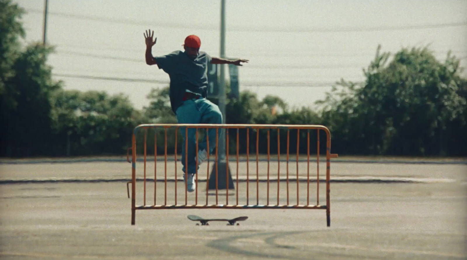 a man riding a skateboard on top of a metal barricade