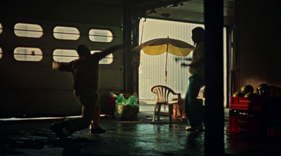 a couple of men standing next to each other in a garage