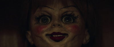 a close up of a creepy doll with big eyes