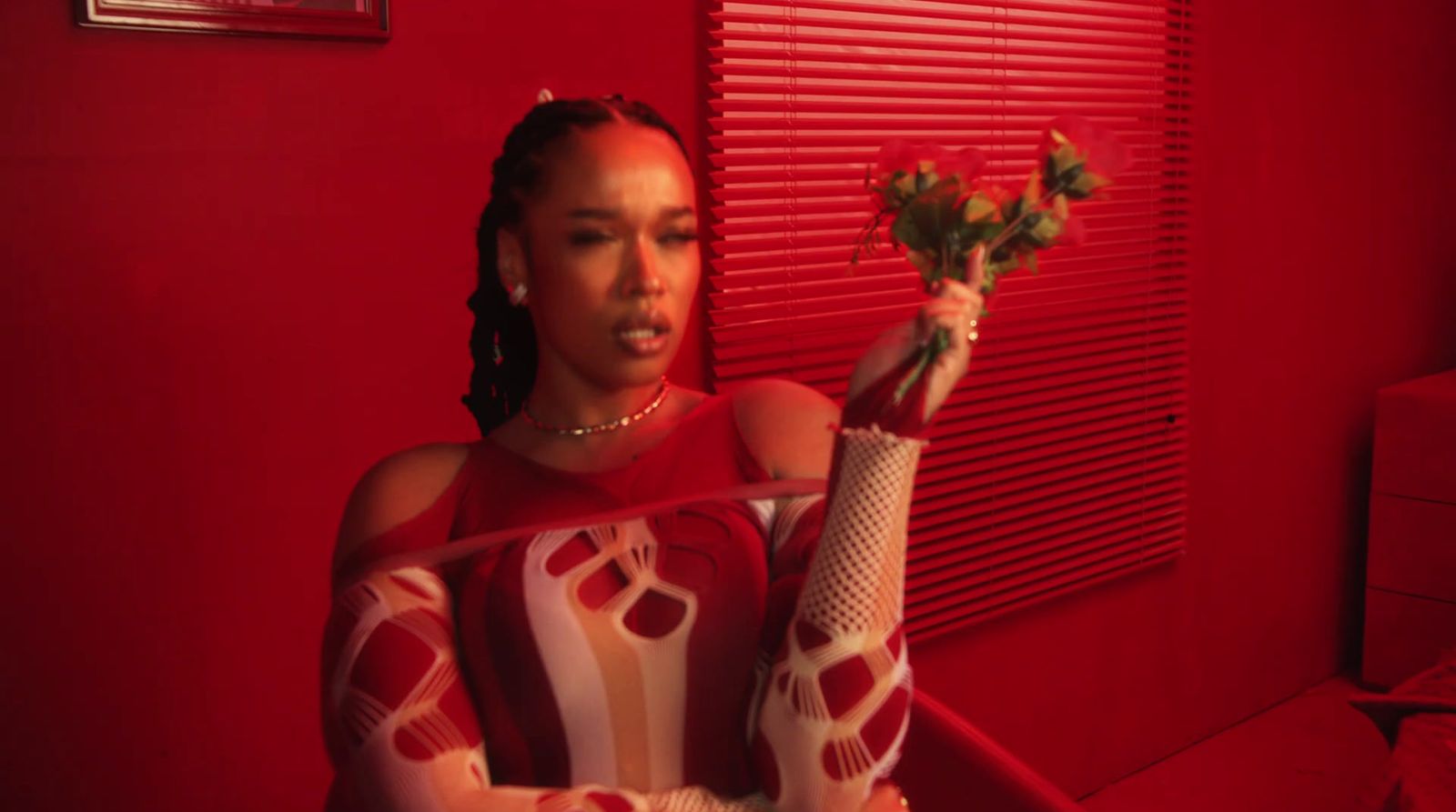 a woman in a red room holding flowers