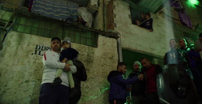 a group of people standing around a building