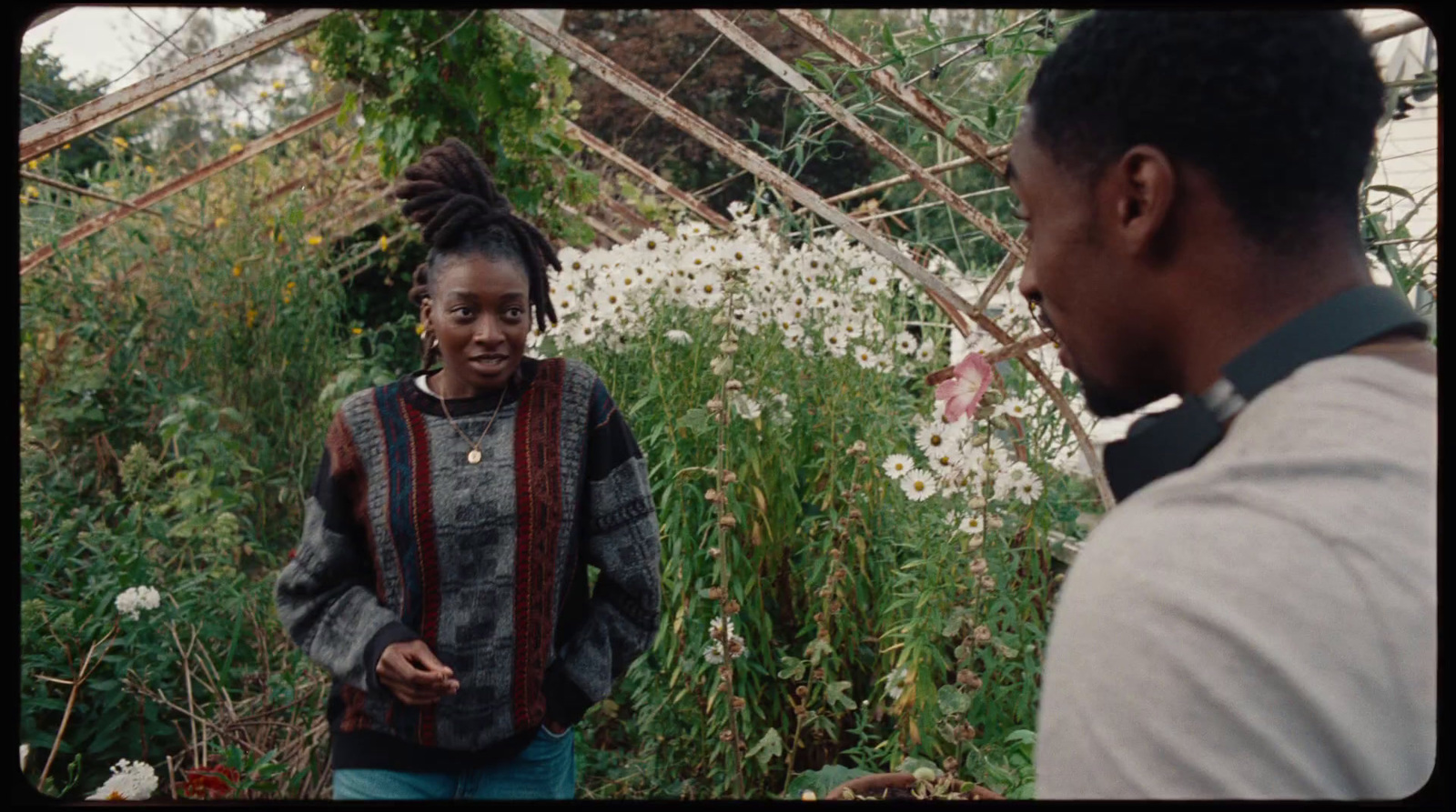 a man standing next to a woman in a garden