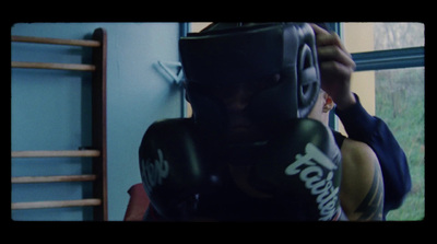 a man wearing boxing gloves and holding a punching mitt