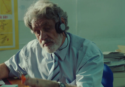 a man wearing headphones sitting at a desk