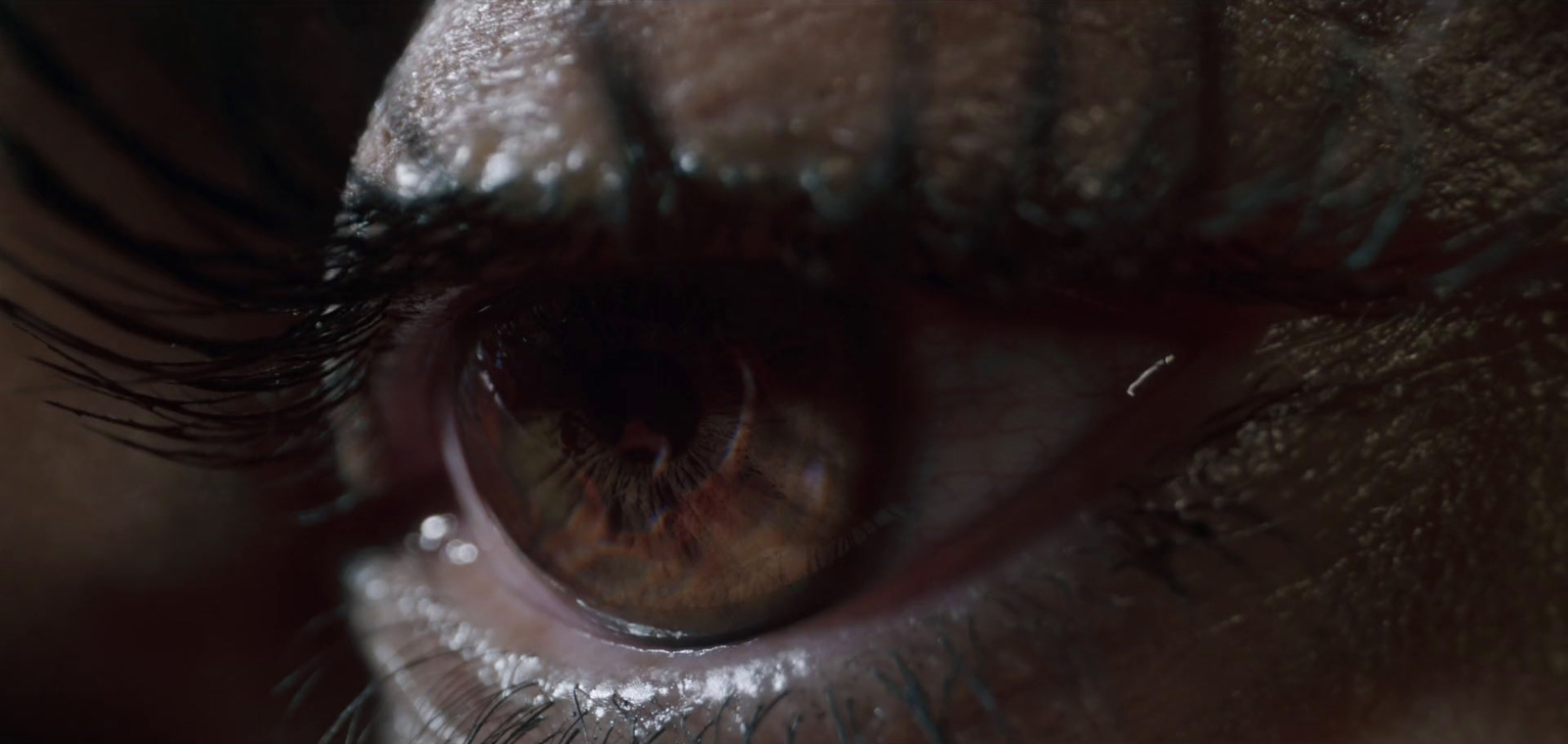 a close up of a person's eye with water droplets on it