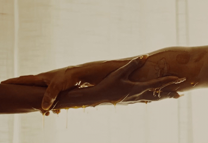 a person's hand is dripping with chocolate