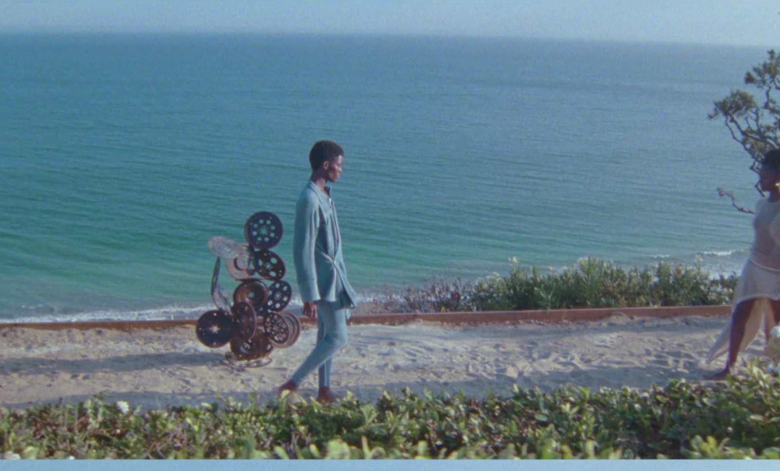 a man and a woman walking on a beach