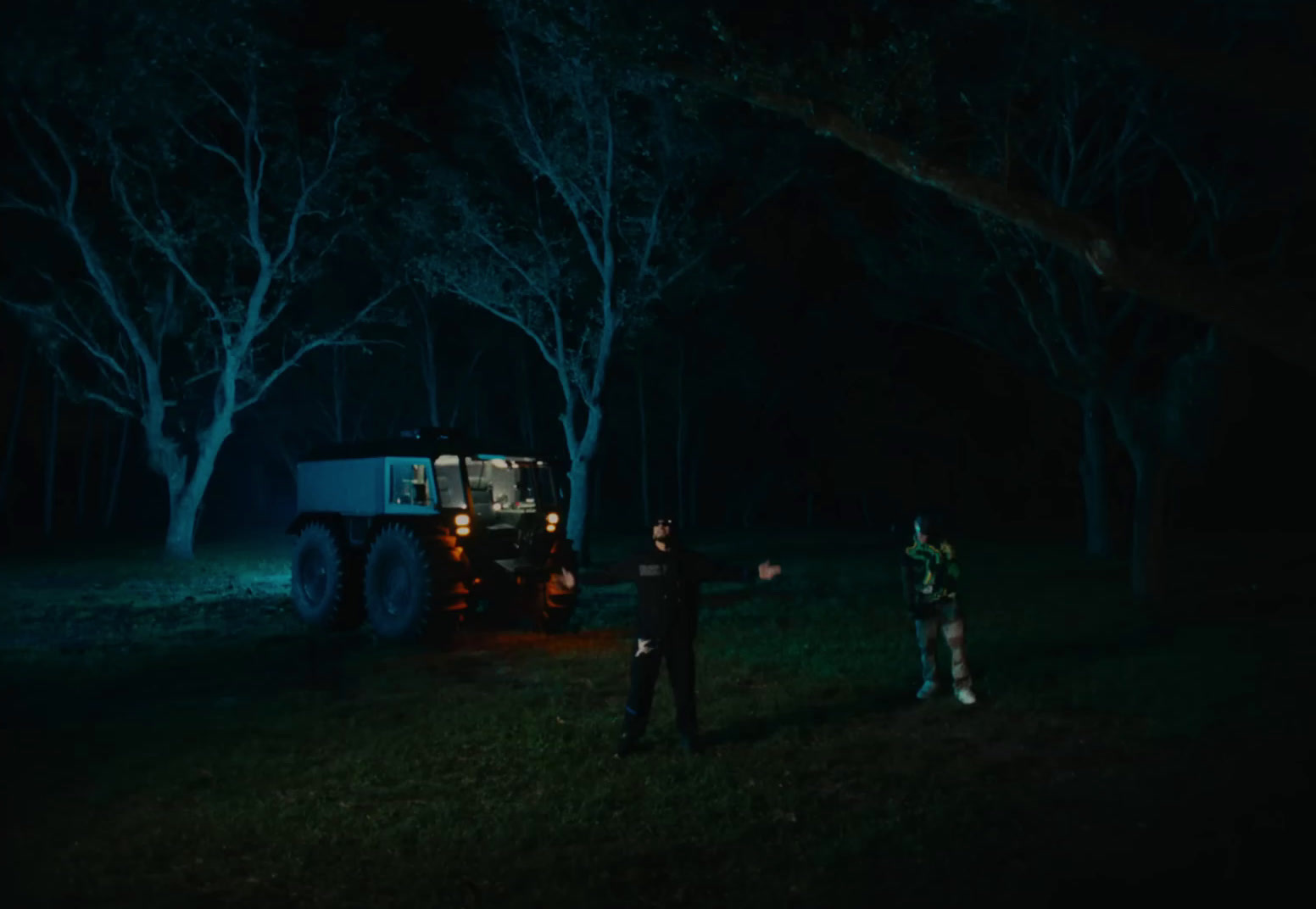 a couple of men standing next to a truck