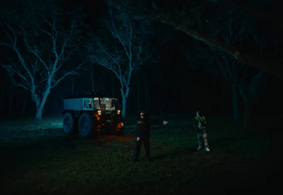 a couple of men standing next to a truck