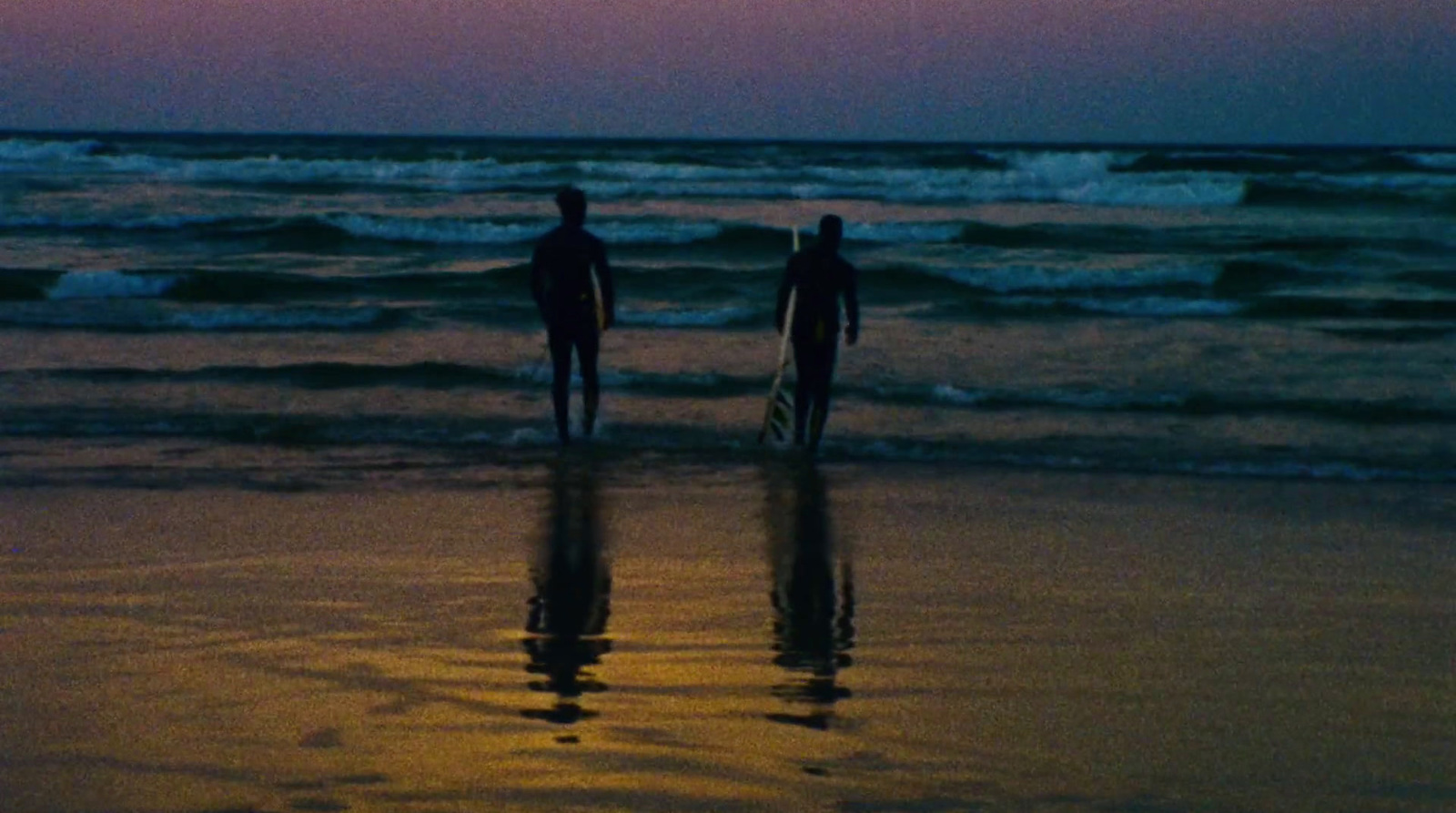 a couple of people that are standing in the water