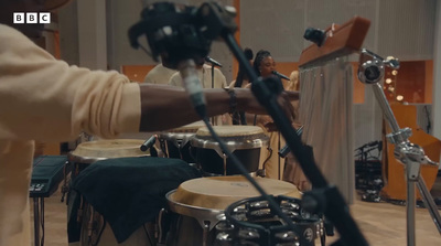 a man is playing a musical instrument in a room