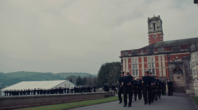 a group of uniformed men walking down a street