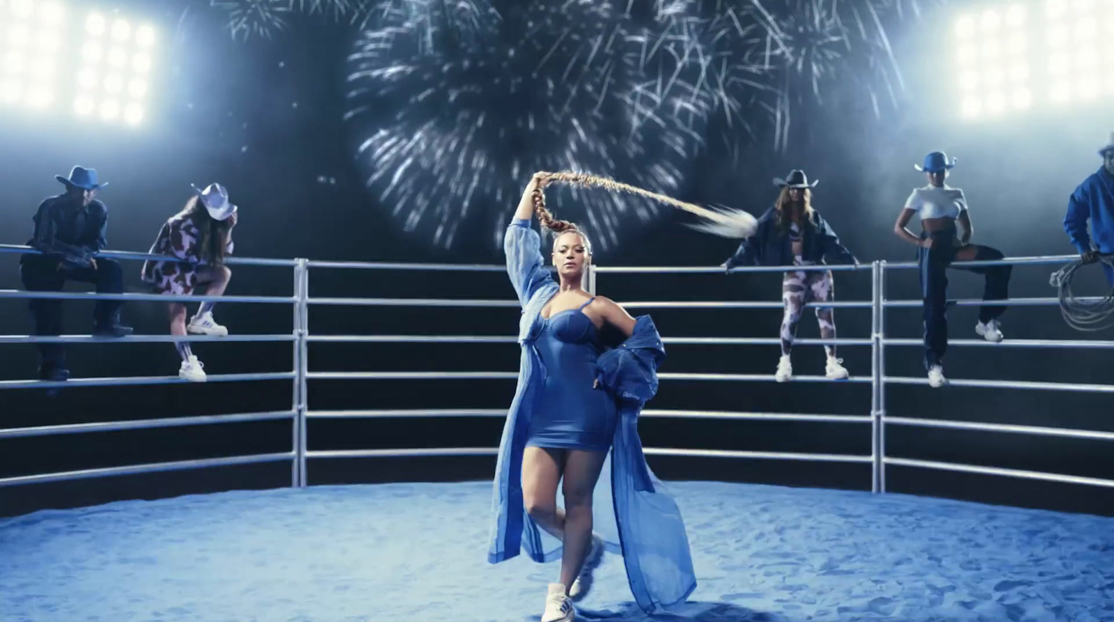 a woman in a blue dress standing in a ring