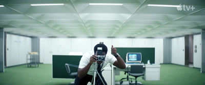 a man taking a picture with a camera in an office