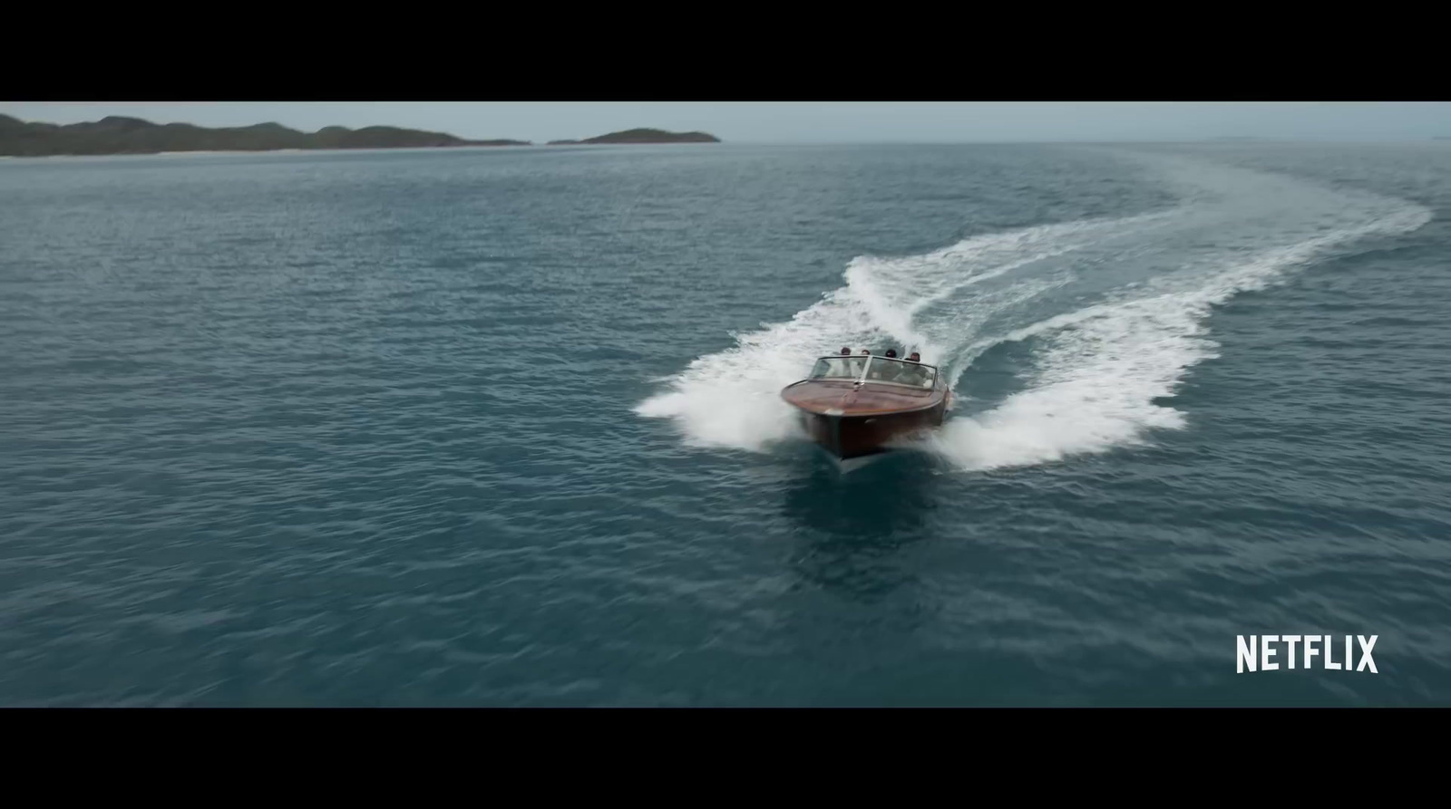 a small boat traveling across a large body of water