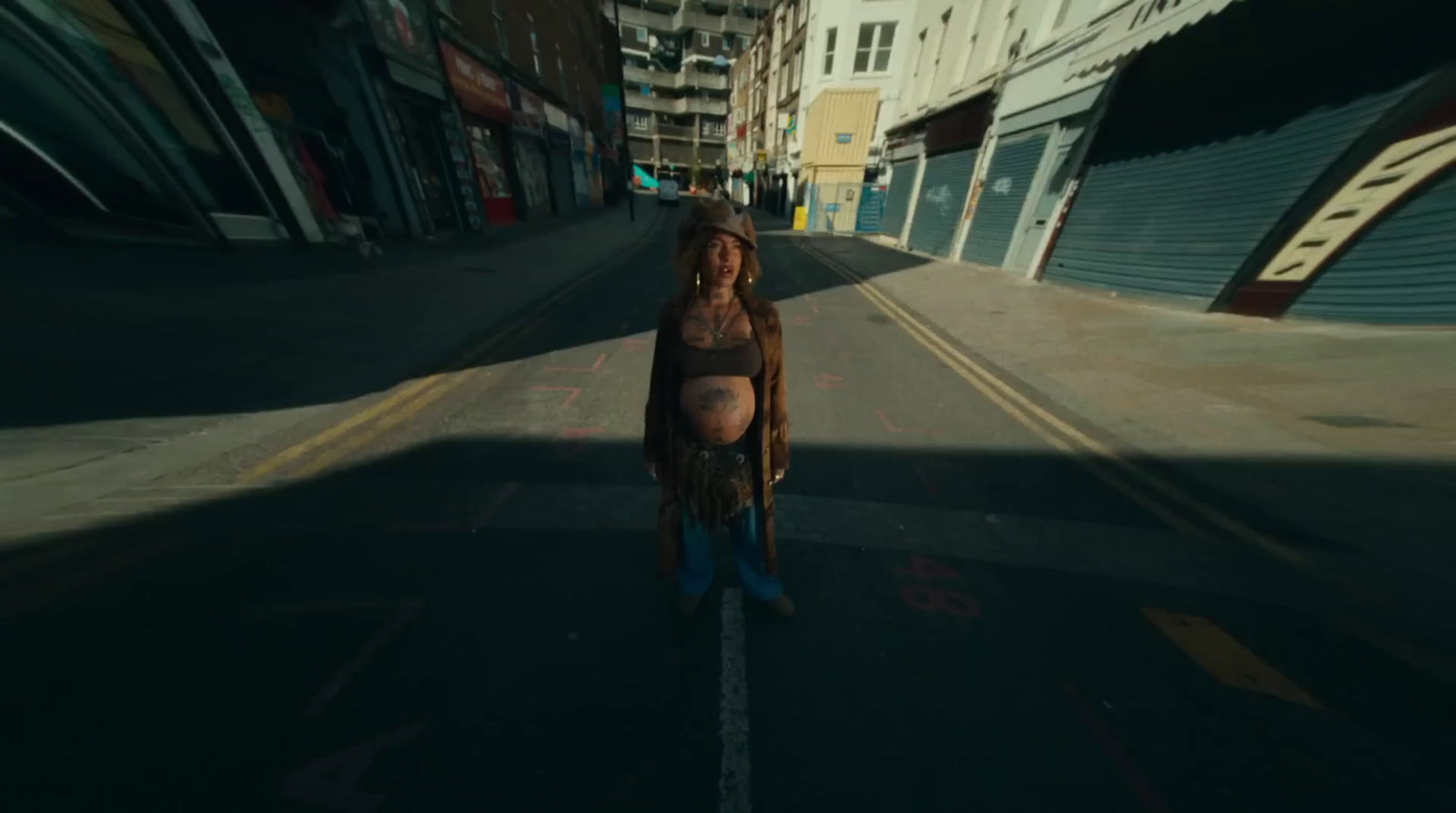 a woman riding a skateboard down a street