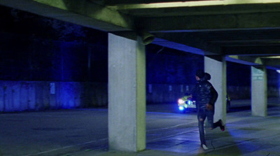 a person walking down a street at night