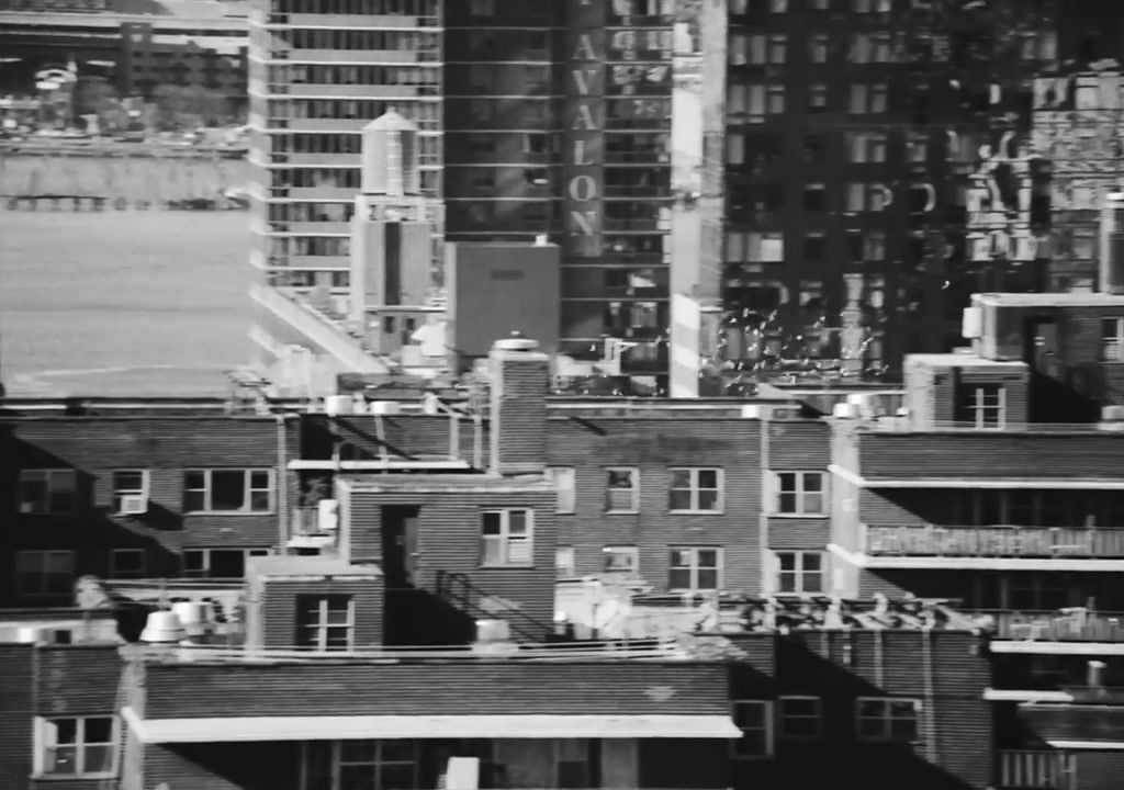 a black and white photo of a city with tall buildings