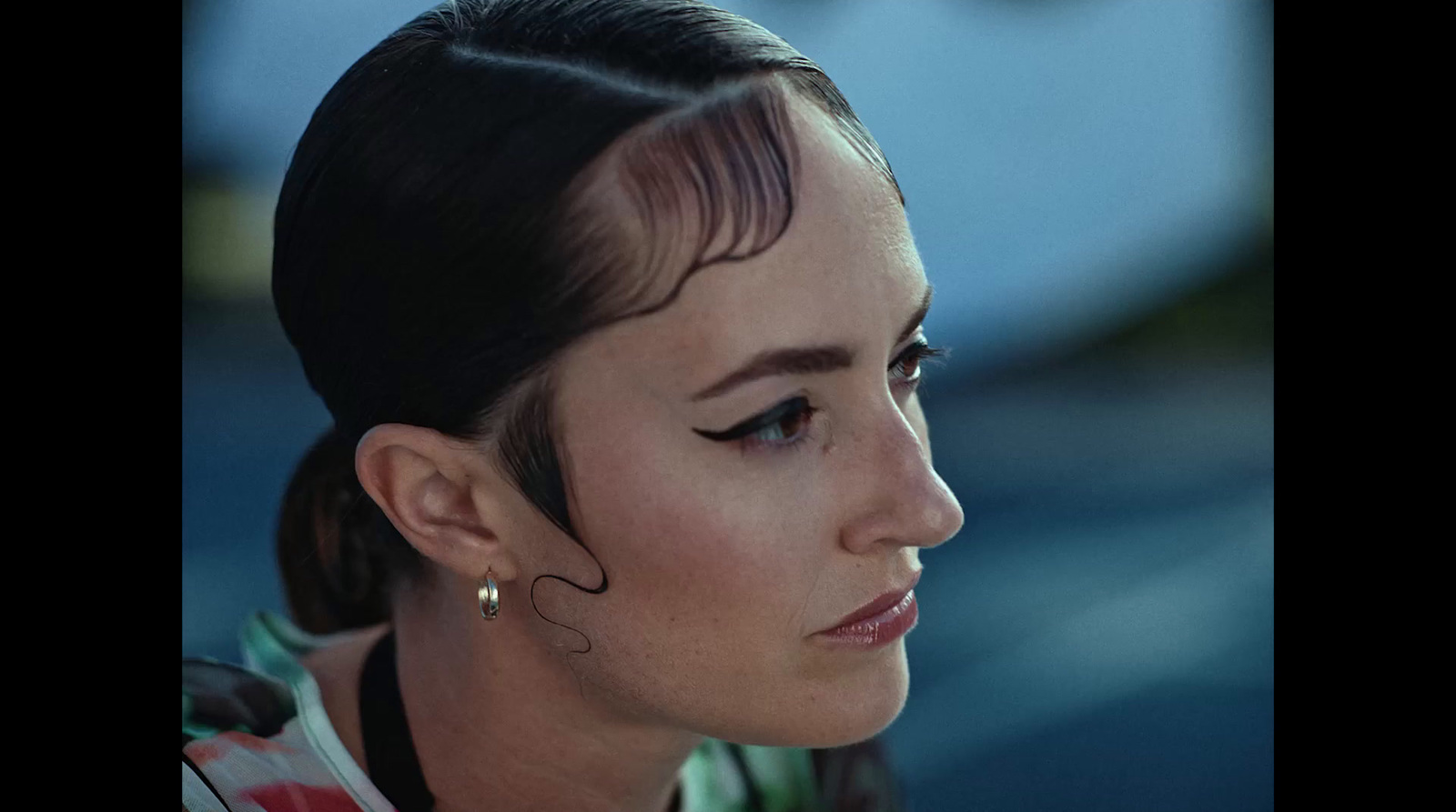 a close up of a person wearing ear rings