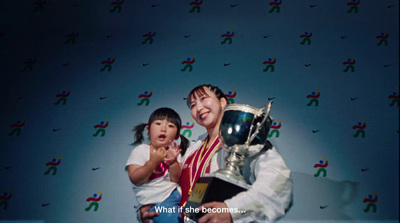 a man holding a trophy next to a little girl