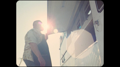 a man is painting the side of a boat