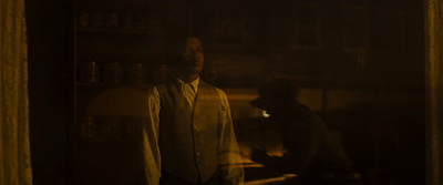 a man standing in front of a mirror in a dark room