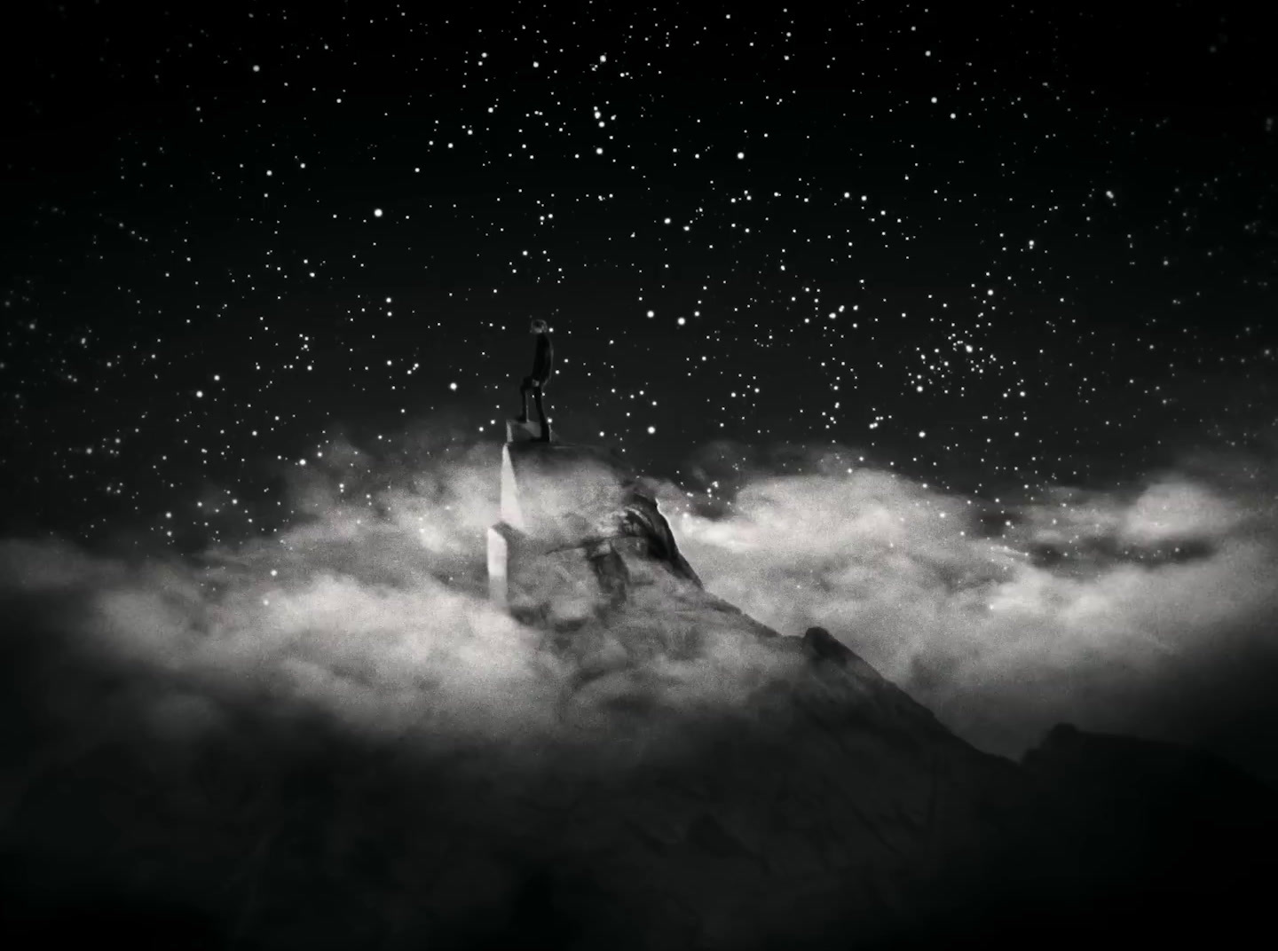 a black and white photo of a castle in the clouds