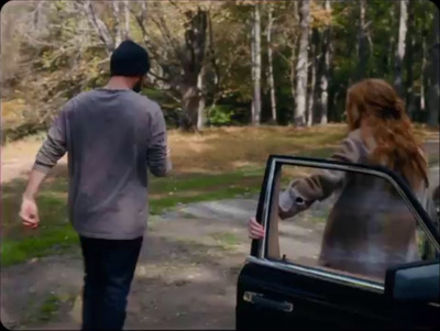 a man and a woman walking away from a car