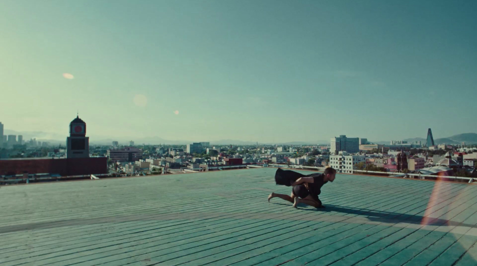 a man sitting on a bench on top of a roof