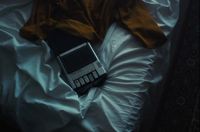 a cell phone laying on top of a white sheet