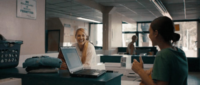 a woman sitting in front of a laptop computer