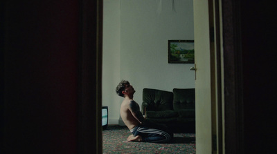 a man sitting on the floor in front of a tv