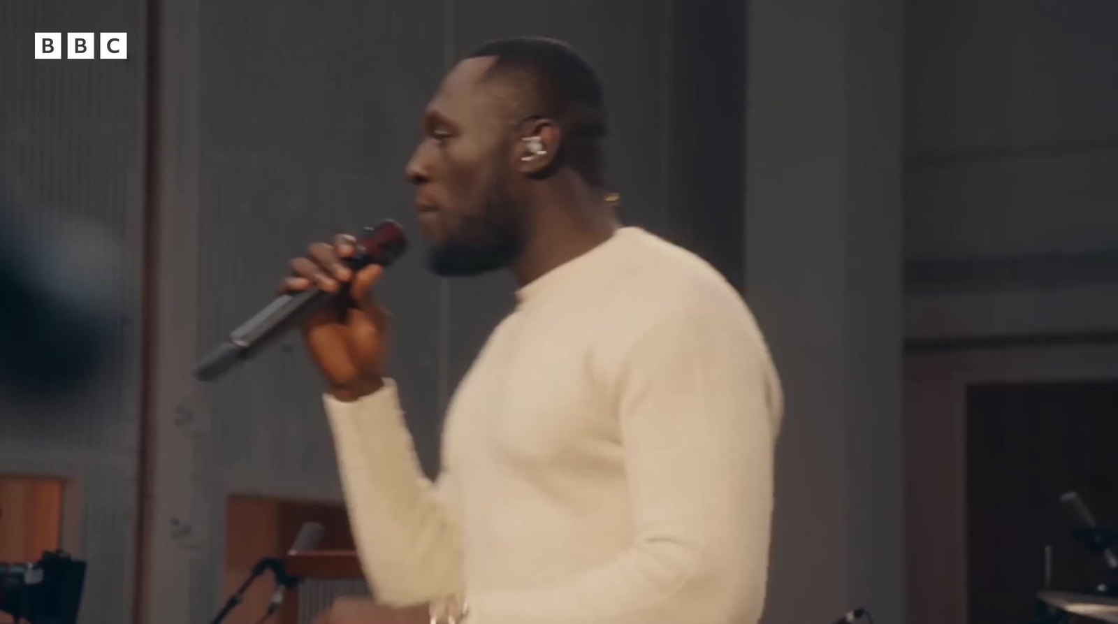 a man standing in front of a microphone