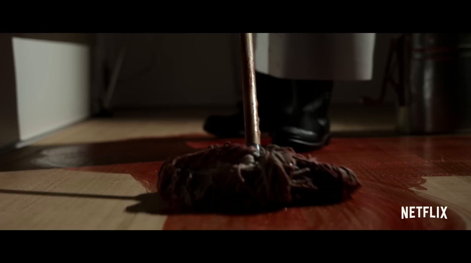 a chocolate lollypop sitting on a wooden floor