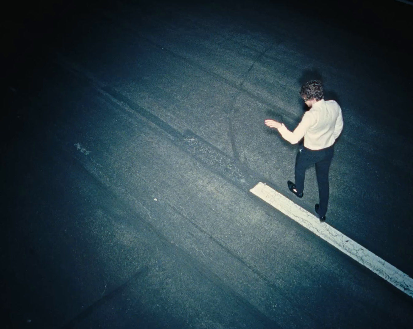 a man is standing on the edge of a street