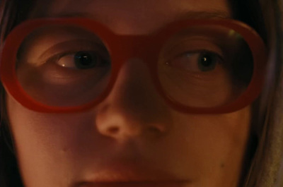 a close up of a person wearing glasses