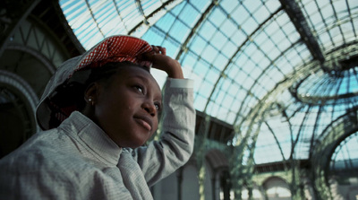 a woman in a white jacket and a red hat