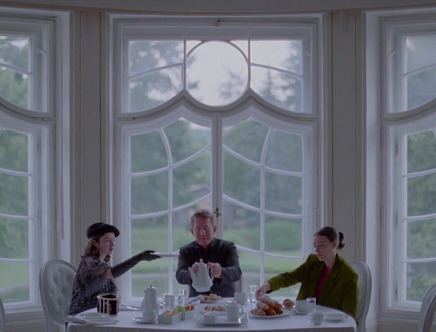 a group of people sitting around a white table