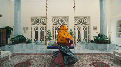 a woman sitting on a swing in a room