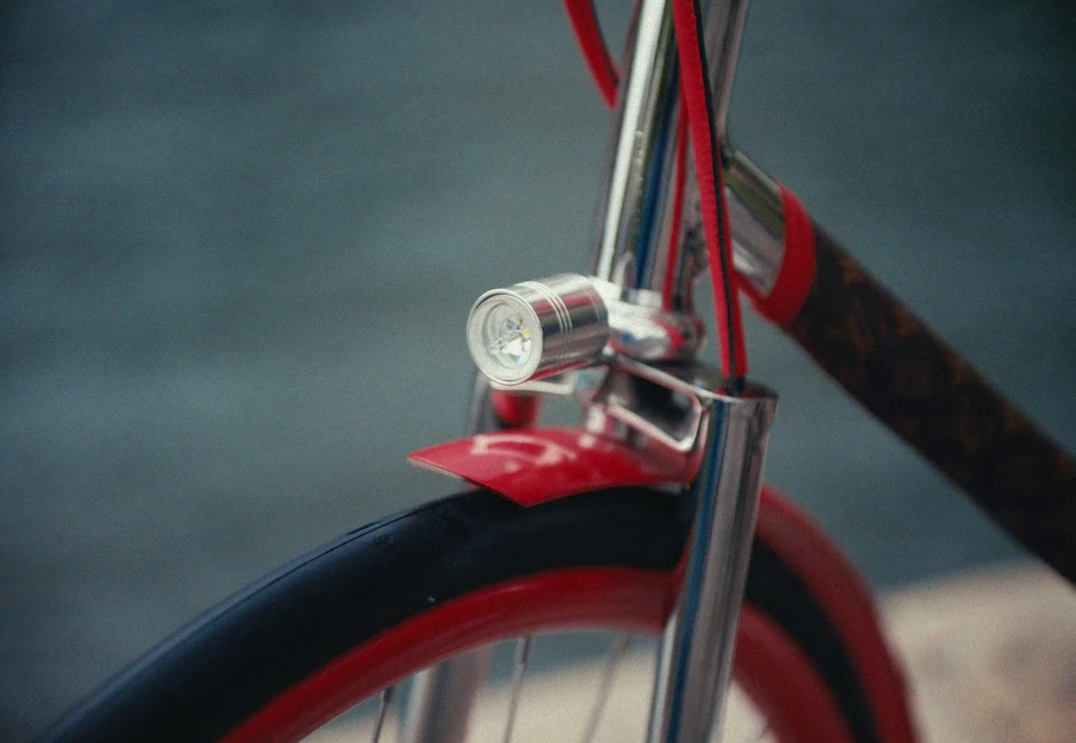 a close up of a red bicycle with a light on it