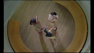 a group of people standing on top of a wooden floor